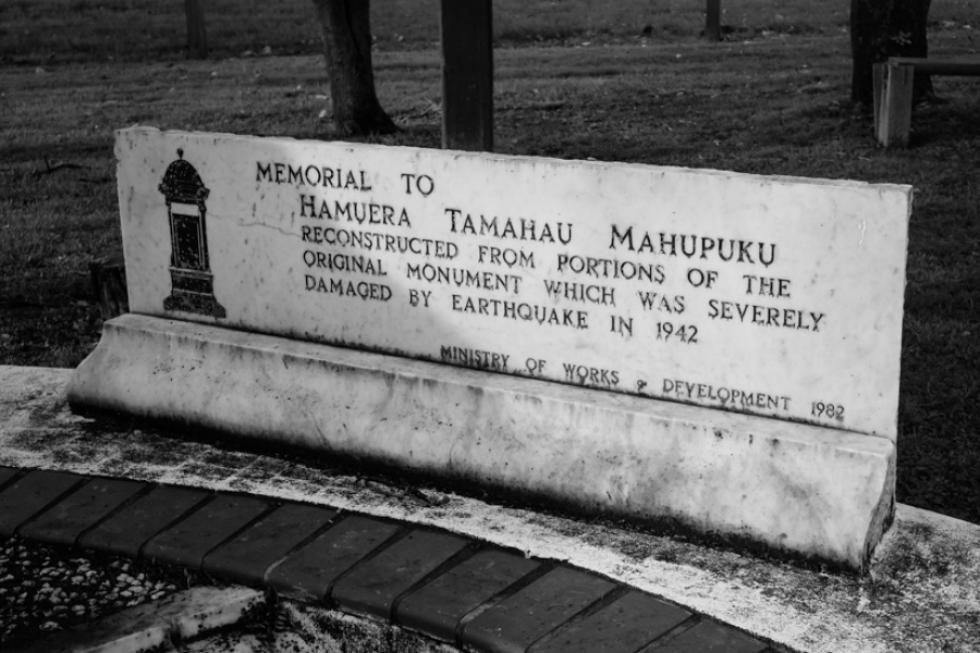 Marble plaque with text on it built into ground.