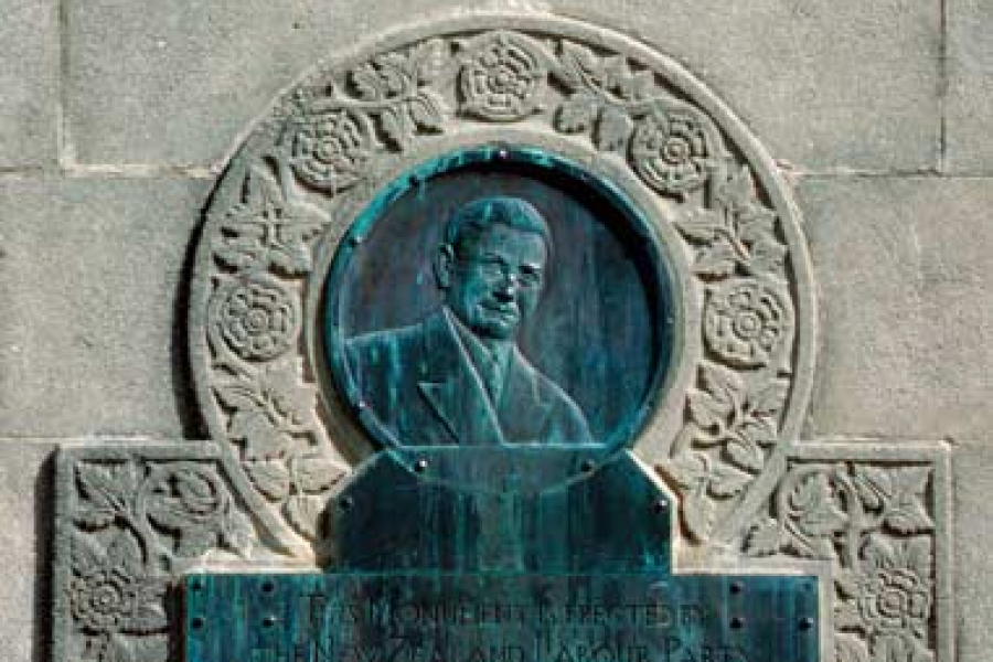 Profile of Michael Joseph Savage and text inland in stone.