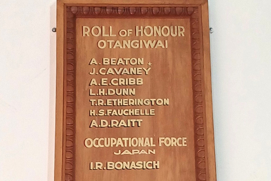 List of names in gold lettering on wooden board