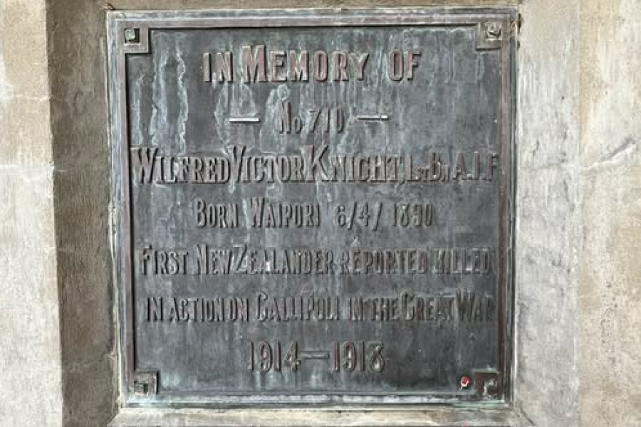 Weather-damaged bronze memorial plaque