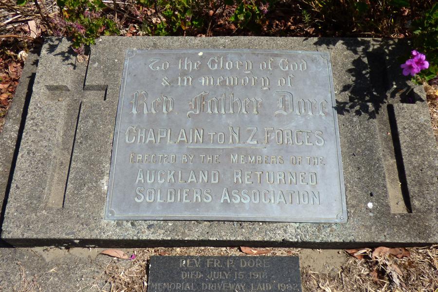 Brass plaque inlaid into ground between two crosses.