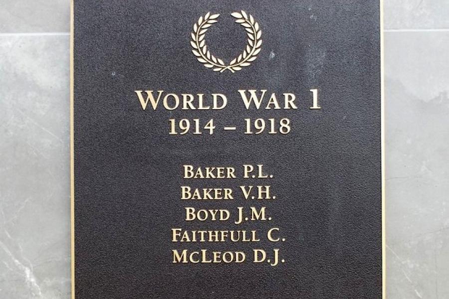Square bronze plaque with list of names in gold under picture of a laurel wreath and heading World War 1 1914-1918