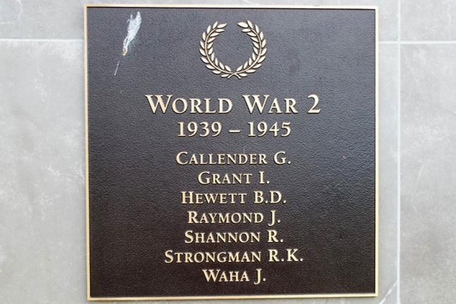 Square bronze plaque with list of names in gold under picture of a laurel wreath and heading World War 2 1939-1945