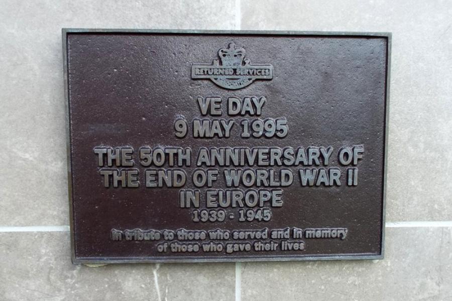 Bronze plaque with text under heading VE Day 9 August 1995