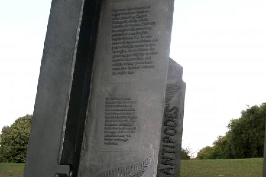 Detail of bronze column featuring text, rugby ball and sliver fern imagery