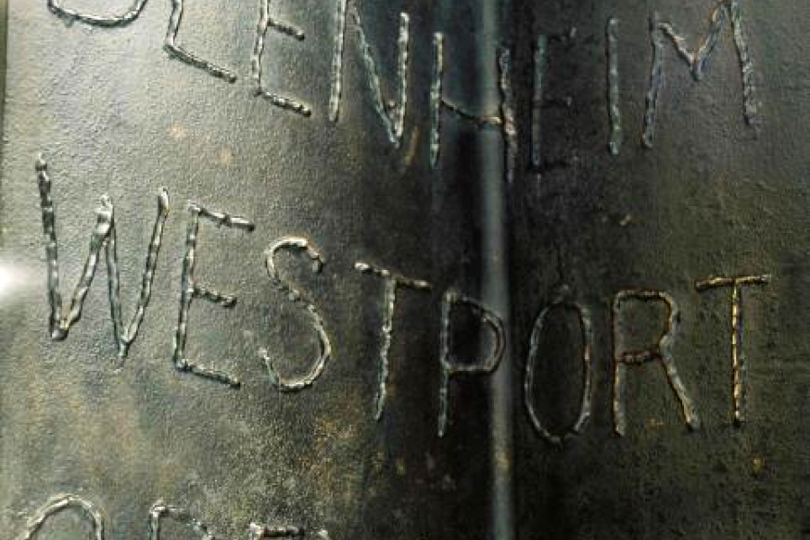 Detail of text on column featuring the words Blenheim, Westport and Greymouth