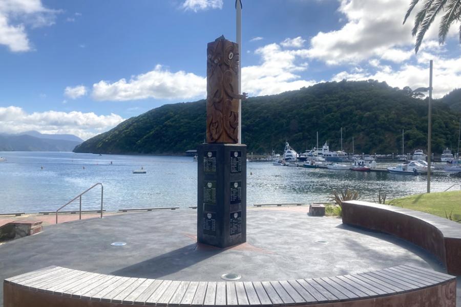 View of carved powhenua memorial to D Company 28th Māori Battalion looking out to sea.