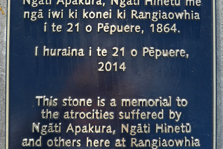 Detail of bronze plaque with gold coloured text in te reo Māori and English