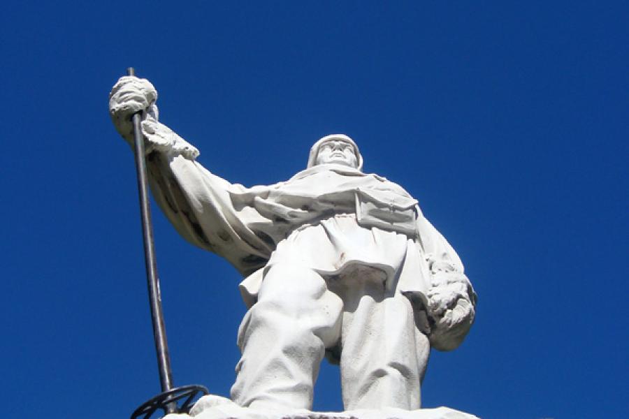 Life-size statue of Robert Scott in Antarctic clothing photographed from below