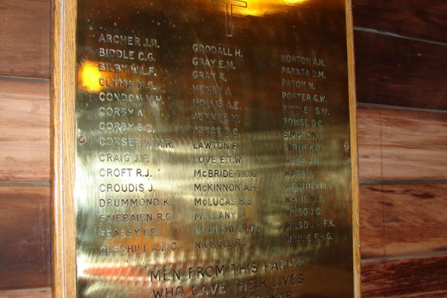 Brass memorial tablet on wall inside the church listing names of members of the St Augustine's Church who died during the Second World War.
