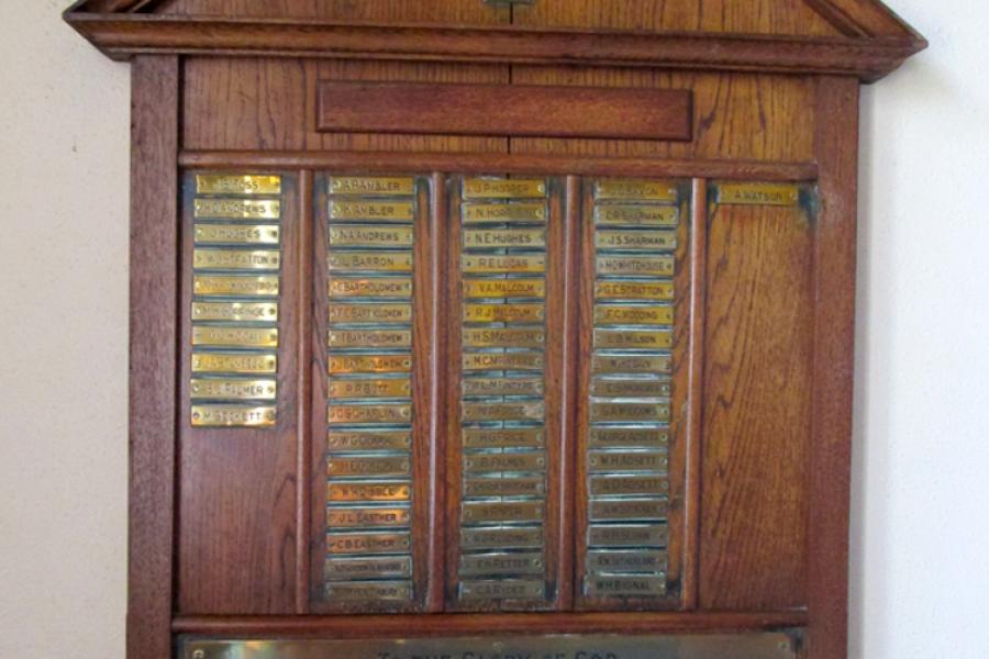 View of wooden roll of honour board with names inscribed on brass plaques