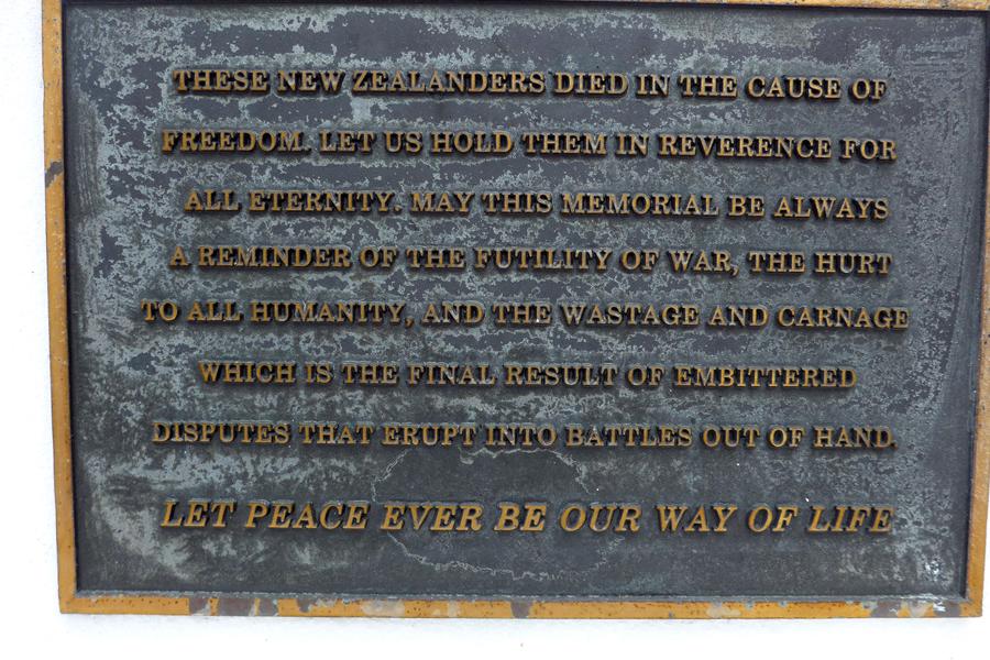 Close up view of brass plaque with writing on it.