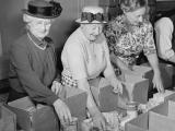 Volunteers pack groceries for CORSO, 1951