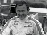 A smiling Bruce McLaren in his racing overalls