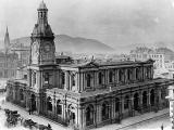 Original University of Otago building with horse-drawn carts in front.