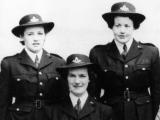 Three uniformed policewomen in group photograph