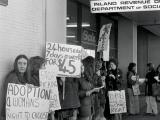 Women demonstrate outside a Social Welfare office, 1977