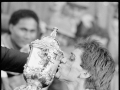 Man in sports uniform kissing a trophy
