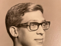 Young man with glasses and a slight smile