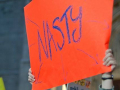 Women holding up 'Nasty' sign