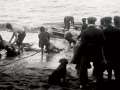 Hauling wreckage and a body ashore at Cape Terawhiti