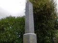 Photograph of an obelisk shaped marble memorial with names listed on each side