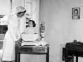 Plunket nurse weighing a baby