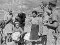New Zealand soldiers talk to Italian refugees