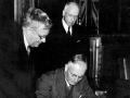 Australian Prime Minister John Curtin signs the Canberra Pact, watched by Australian Minister of External Affairs H.V. Evatt