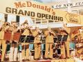 Brass band playing under 'McDonald's Grand Opening' sign