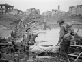 NZ soldiers crossing destroyed Italian bridge