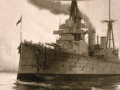 HMS New Zealand on the water with smoke pouring out of chimney.