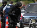 Armed police search a vehicle near Rūātoki