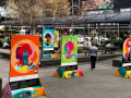 An urban park decorated with five large colourful posters.