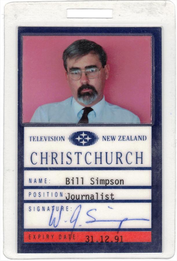 Identification card featuring text and picture of a bearded man with glasses in shirt and tie