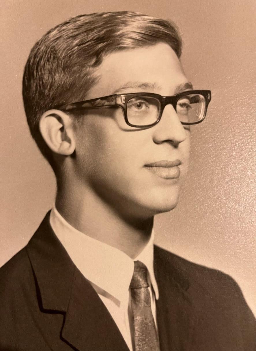 Young man with glasses and a slight smile
