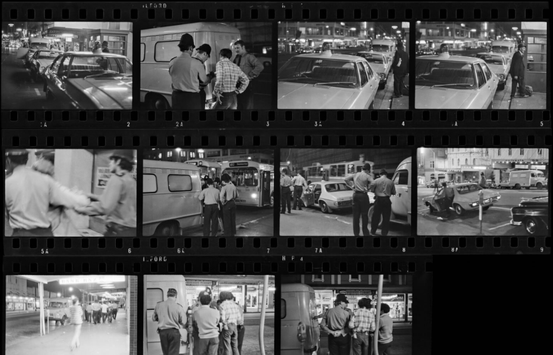 Black and white photo negatives of police in uniform at a hotel.