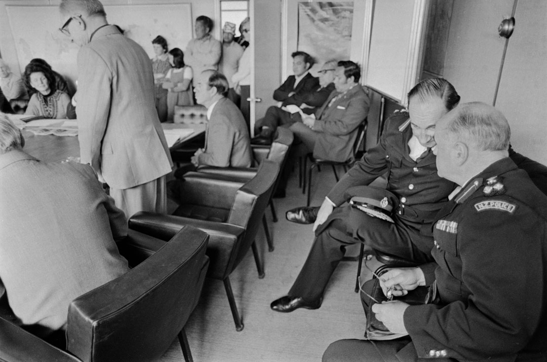 Two seated policemen in conversation while attending a meeting