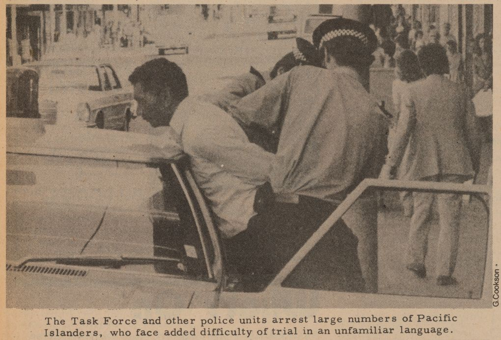 Man being arrested by police who have pushed him against car handcuffed him