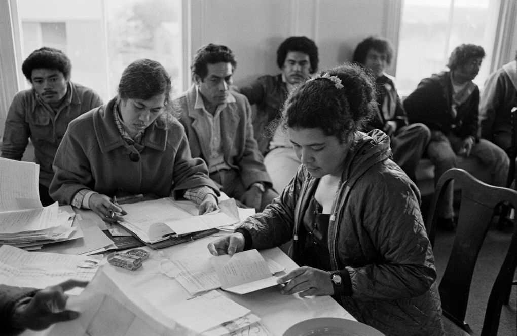 Group of people at a table looking at papers