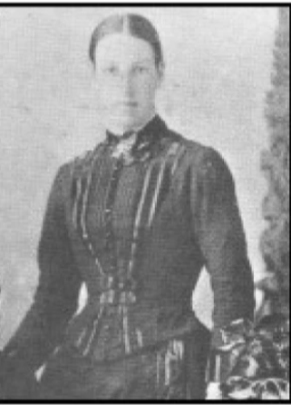 Woman in black dress with tightly pulled back hair