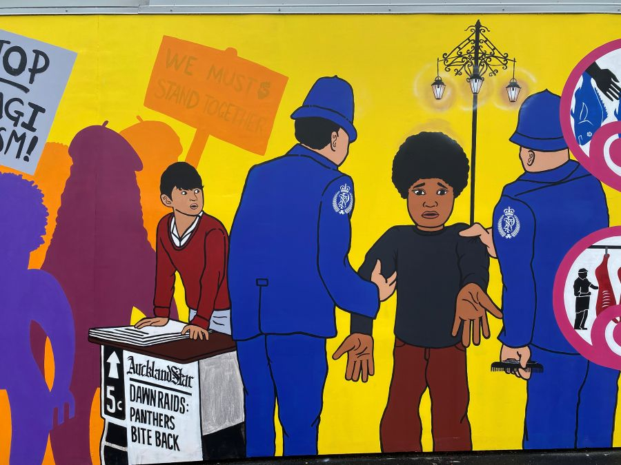 Mural depicting police arresting a man with newspaper declaring 'Dawn Raids Panthers Bite Back'