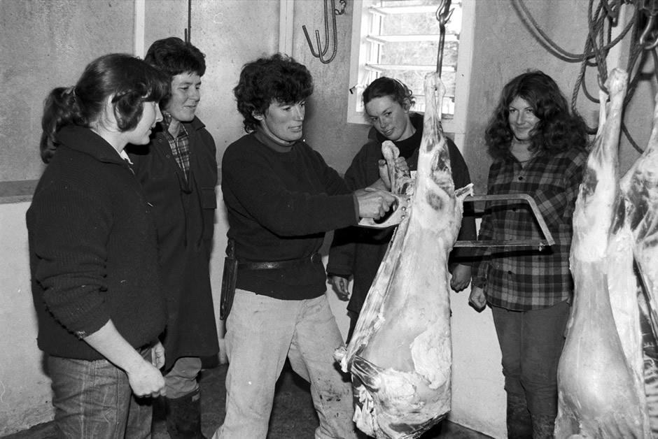 Women standing around a carcass
